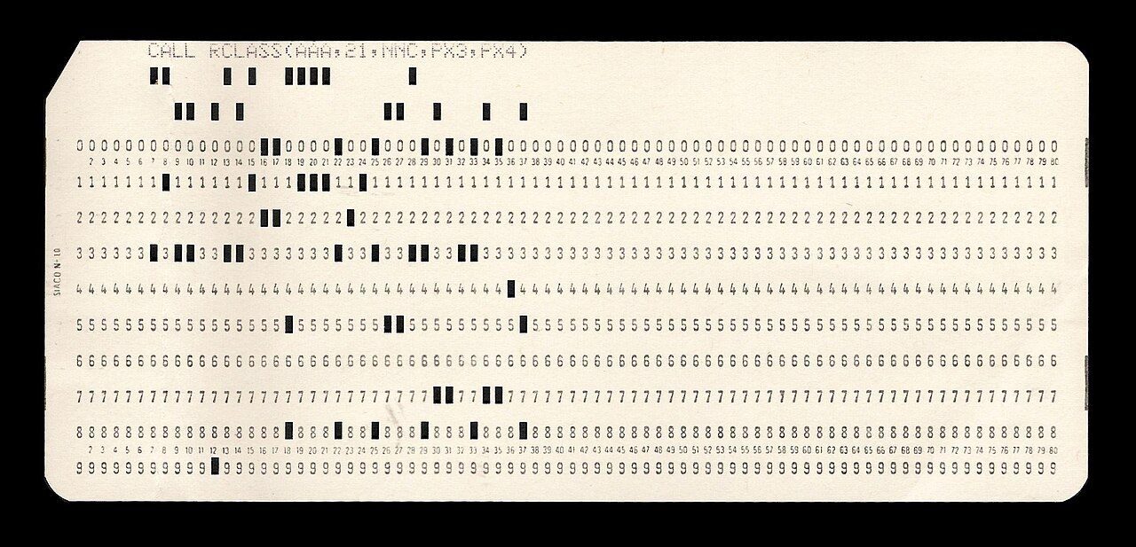 A cream paper card with columns of printed digits and small punched holes