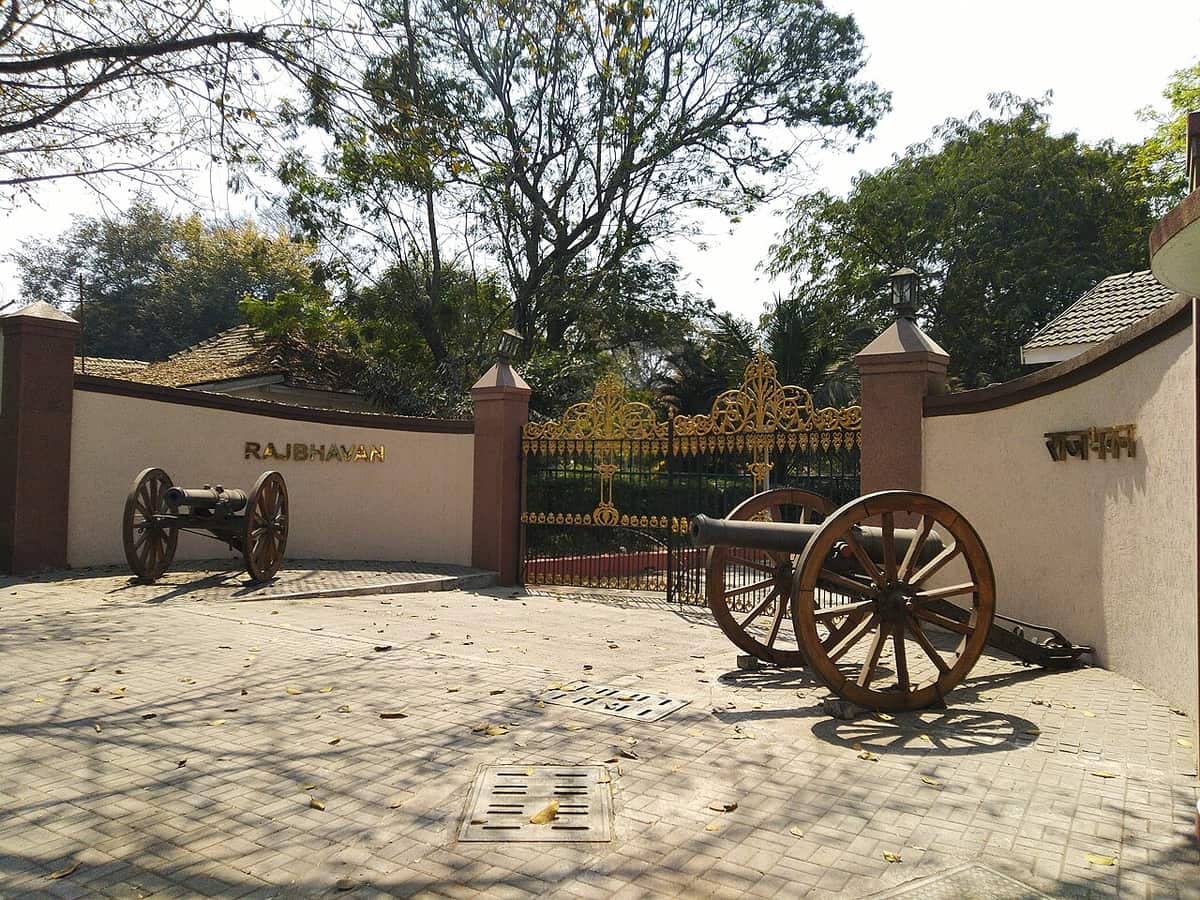 The gated entrance of Raj Bhavan in Pune with a guard post and trees