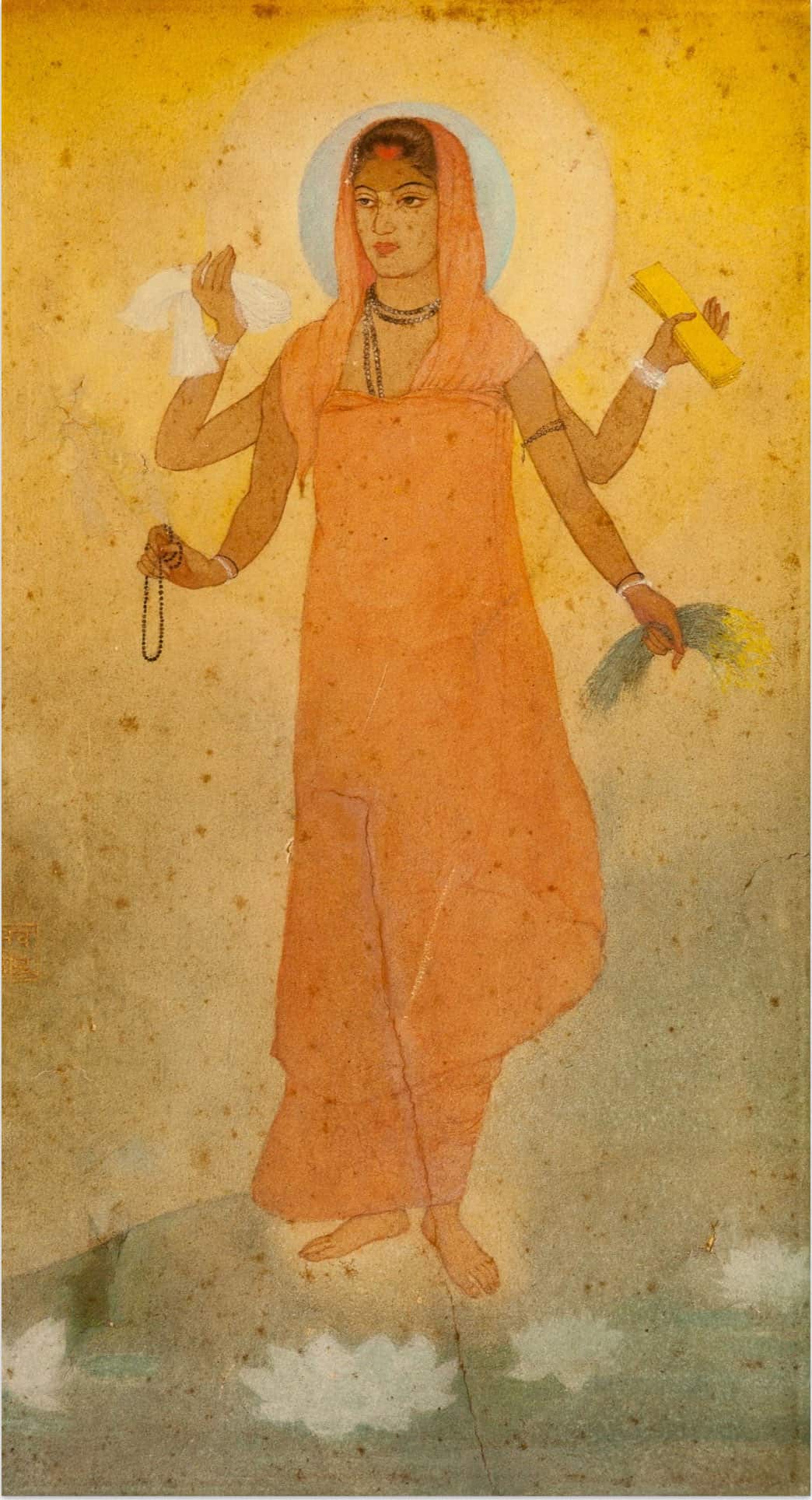 ਕੇਸਰੀ ਬਸਤਰਾਂ ਵਾਲੀ ਚਾਰ ਬਾਹਾਂ ਵਾਲੀ ਔਰਤ ਦੀ ਪੇਂਟਿੰਗ, ਜਿਸ ਦੇ ਹੱਥਾਂ ਵਿੱਚ ਕਿਤਾਬ, ਝੋਨੇ ਦੀ ਪੂਲੀ, ਕੱਪੜਾ ਅਤੇ ਮਾਲਾ ਹੈ