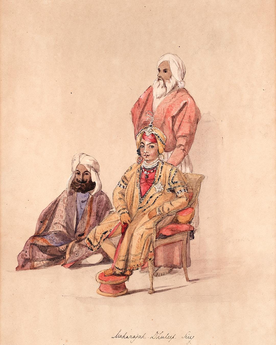 ਆਲੇ-ਦੁਆਲੇ ਖੜ੍ਹੇ ਸੇਵਾਦਾਰਾਂ ਨਾਲ ਬੈਠੇ ਬਾਲ ਮਹਾਰਾਜਾ ਦਲੀਪ ਸਿੰਘ ਦੀ ਤਸਵੀਰ