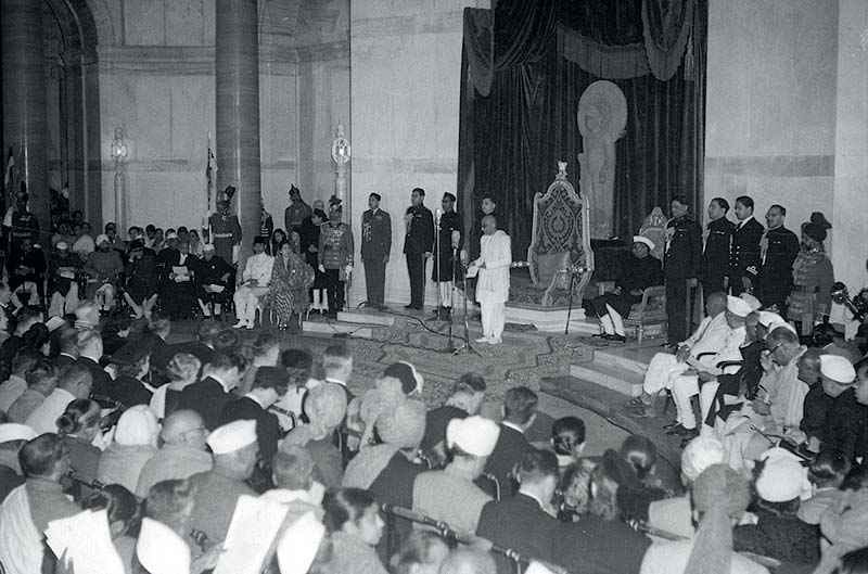 Black and white photograph of C. Rajagopalachari reading a declaration in a large hall