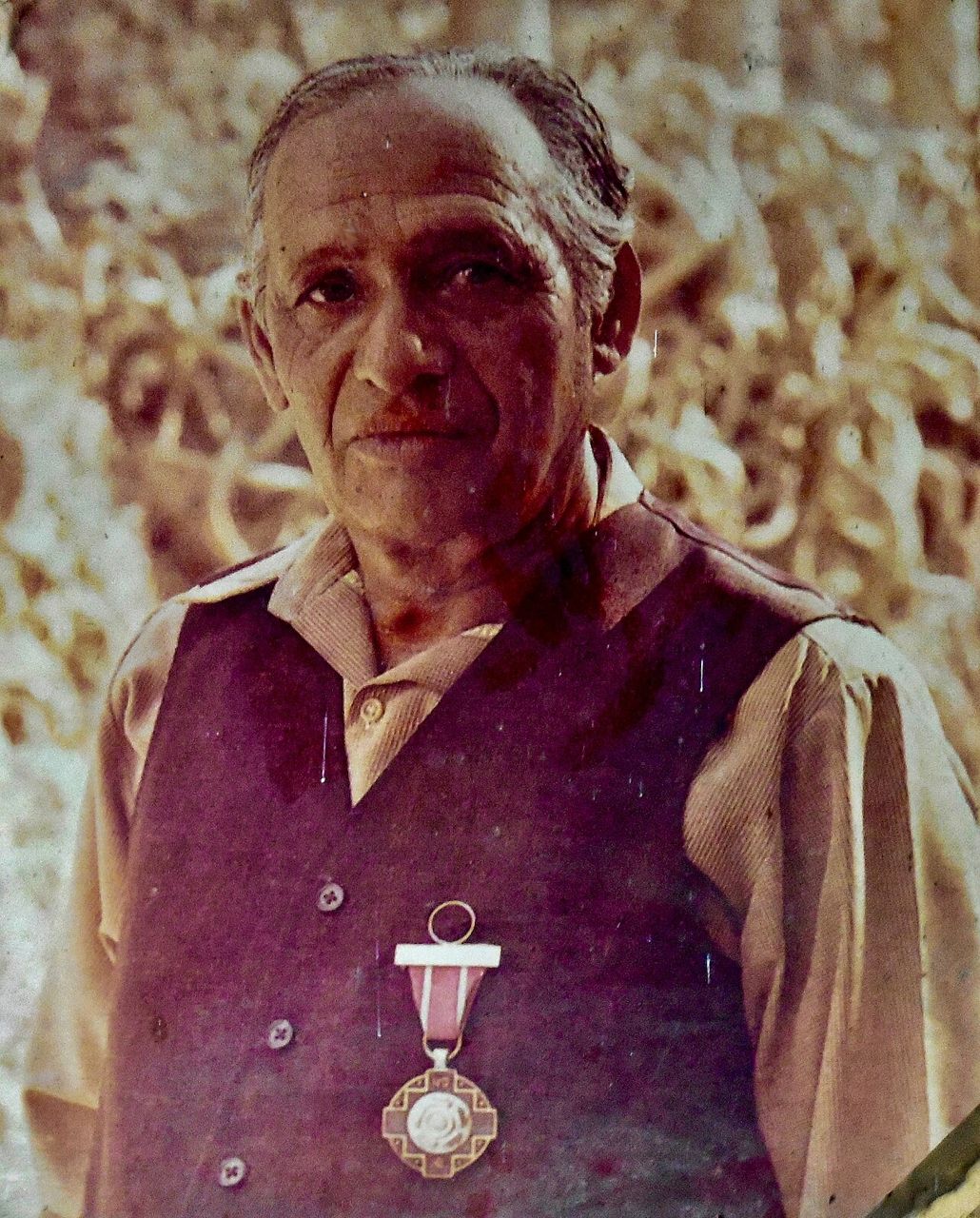 Colour photograph of Nek Chand, an elderly man wearing a medal, 1984