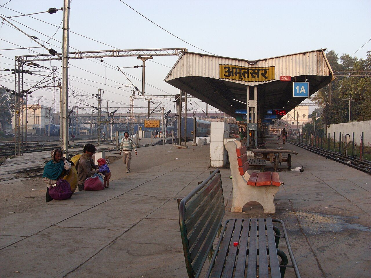 Platform of Amritsar railway station with the station name board and benches