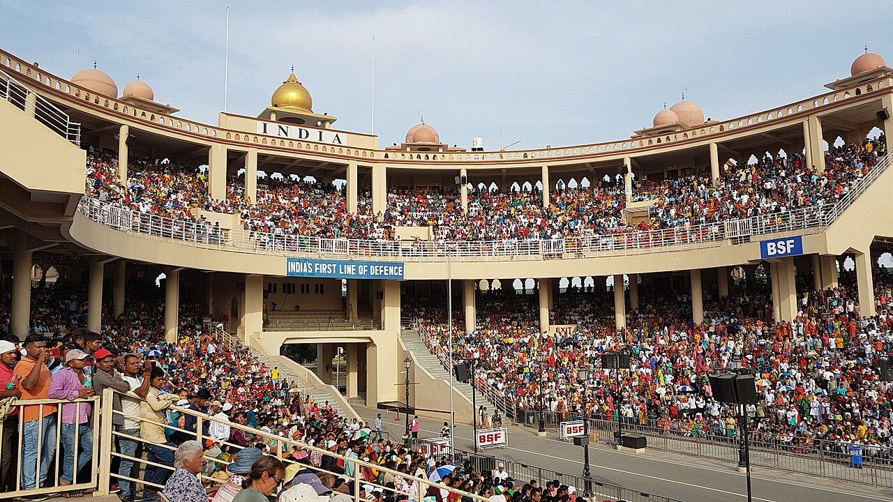 Crowded stands of the Attari border ceremony arena with an 'India' gateway