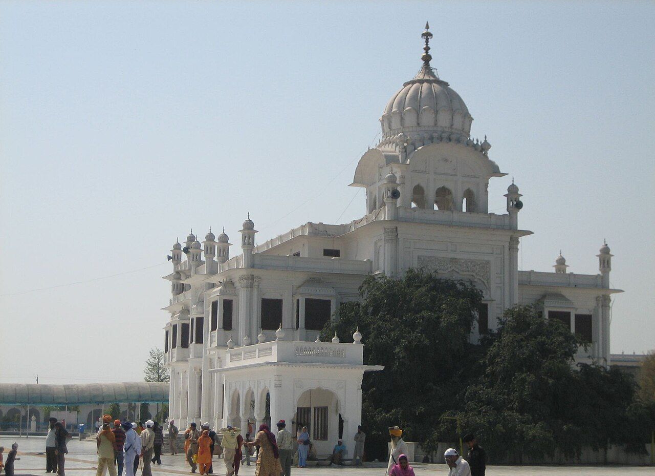 White domed building of Gurdwara Ber Sahib at Sultanpur Lodhi, with visitors in front
