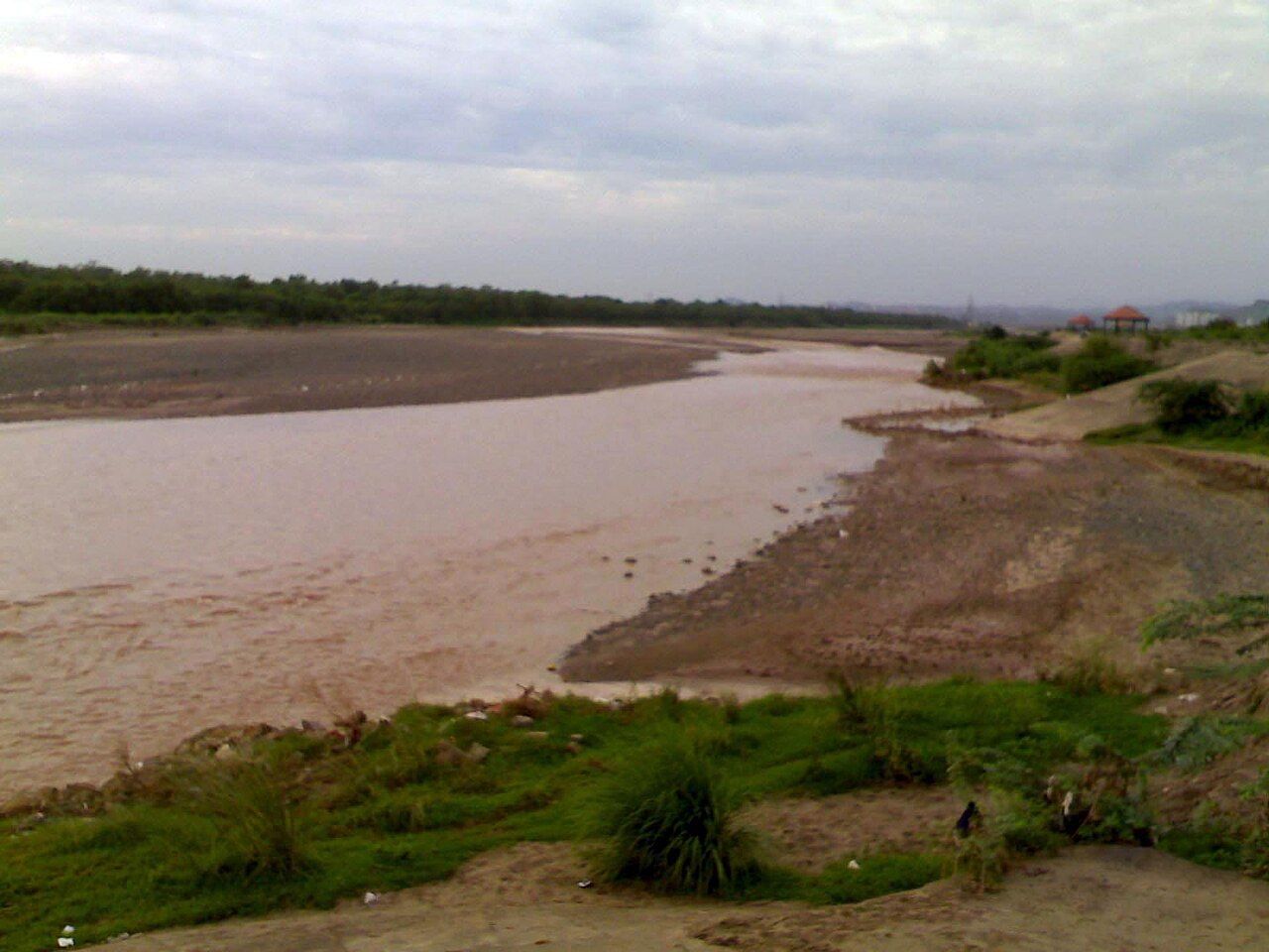 The shallow, muddy Ghaggar flowing over a wide sandy bed at Panchkula