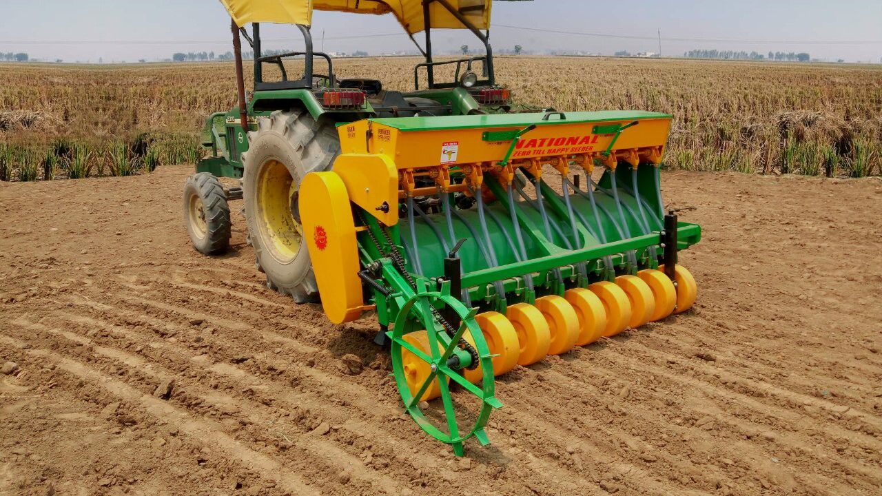 A tractor-drawn Happy Seeder machine standing in a field