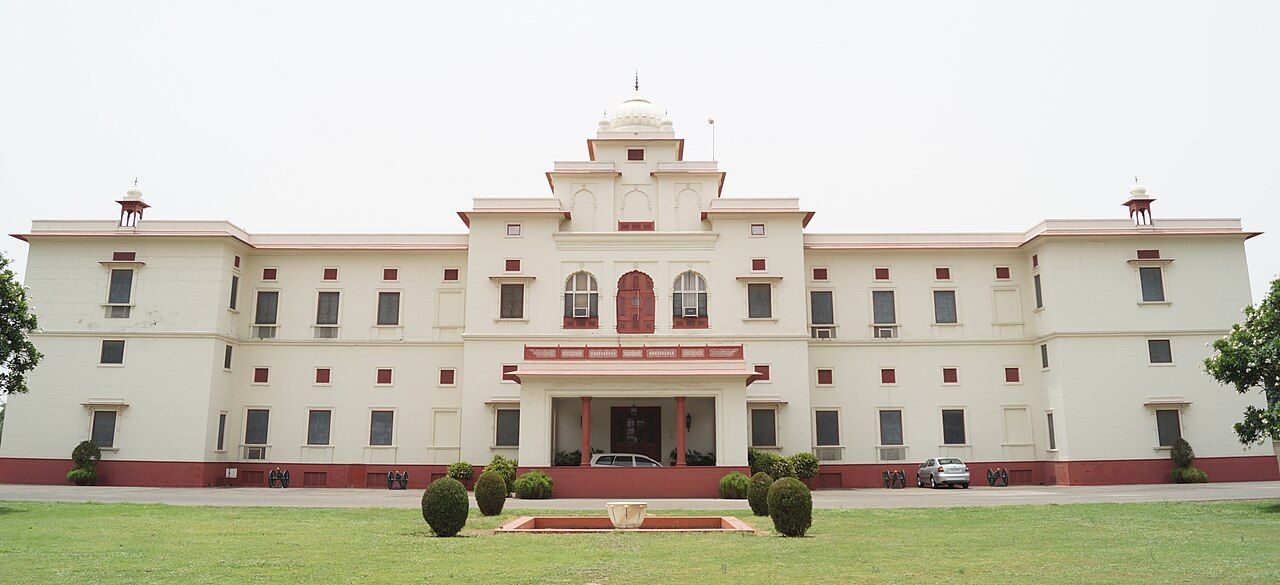 The long cream facade of the Moti Bagh Palace, Patiala, behind a lawn