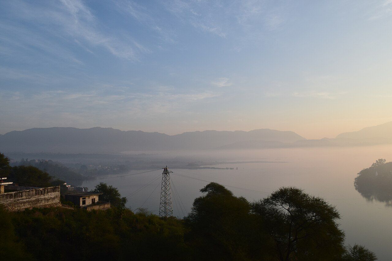 Morning view of the calm Nangal reservoir with hills behind