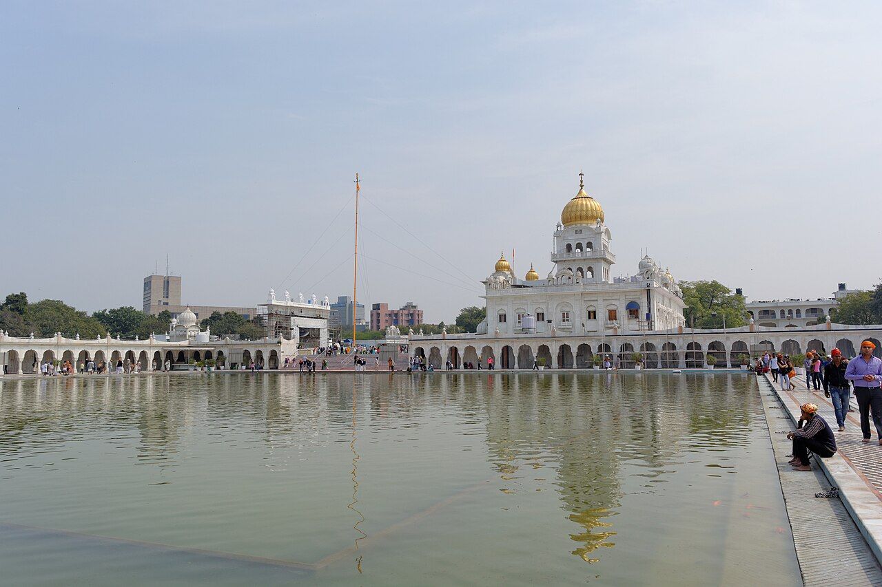 Gurdwara Bangla Sahib with its golden dome reflected in a large pool, New Delhi
