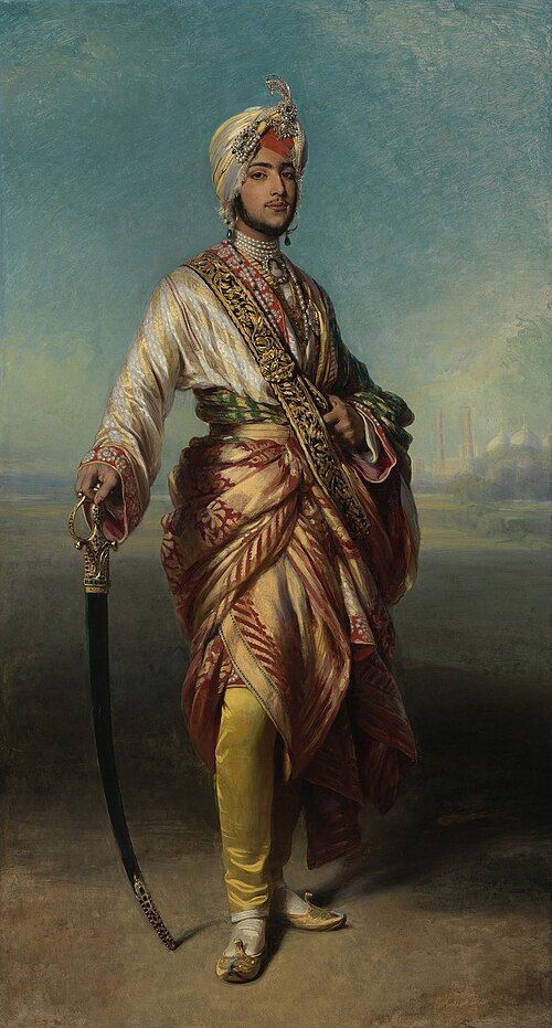 Full-length painting of the young Maharaja Duleep Singh in a jewelled turban and silk robes, holding a sword