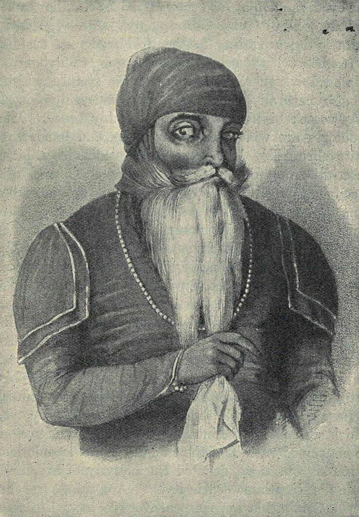Black-and-white printed portrait of Maharaja Ranjit Singh with a long white beard and turban