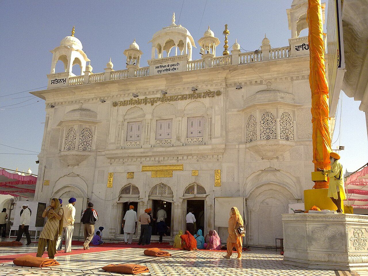 Front of Takht Hazur Sahib with a tall saffron Nishan Sahib and pilgrims