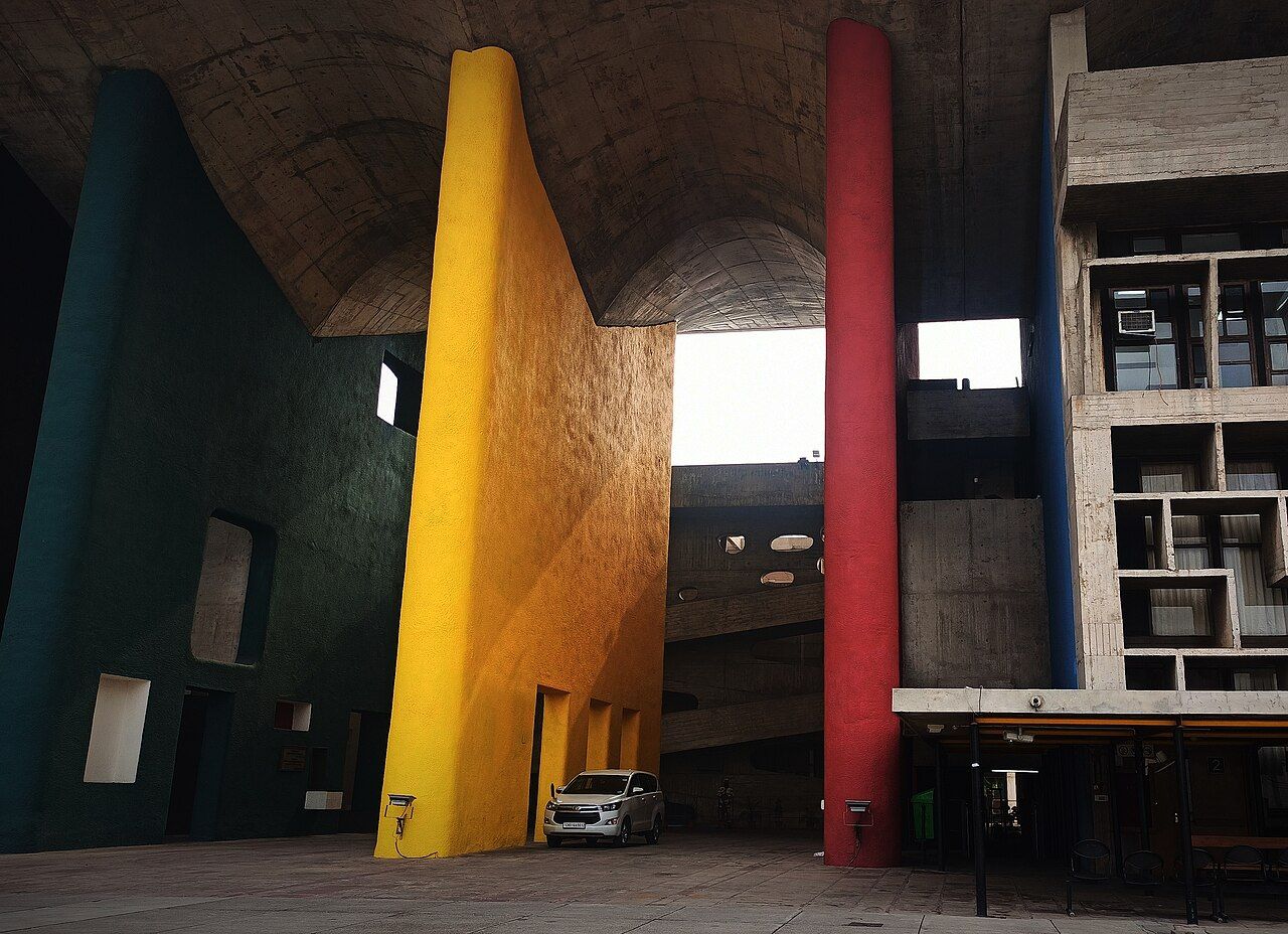Tall coloured pillars in yellow, red and green under the concrete roof of the High Court