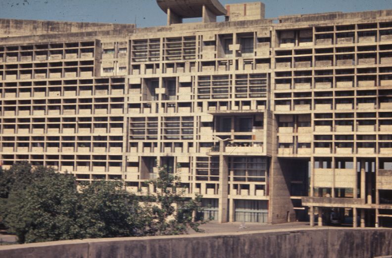 Long concrete Secretariat building with rows of deep window frames
