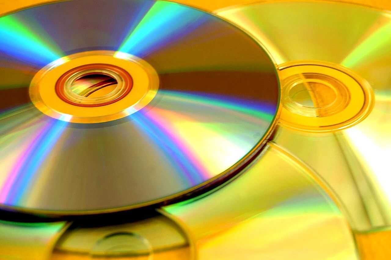 Shiny CDs and DVDs reflecting rainbow colours